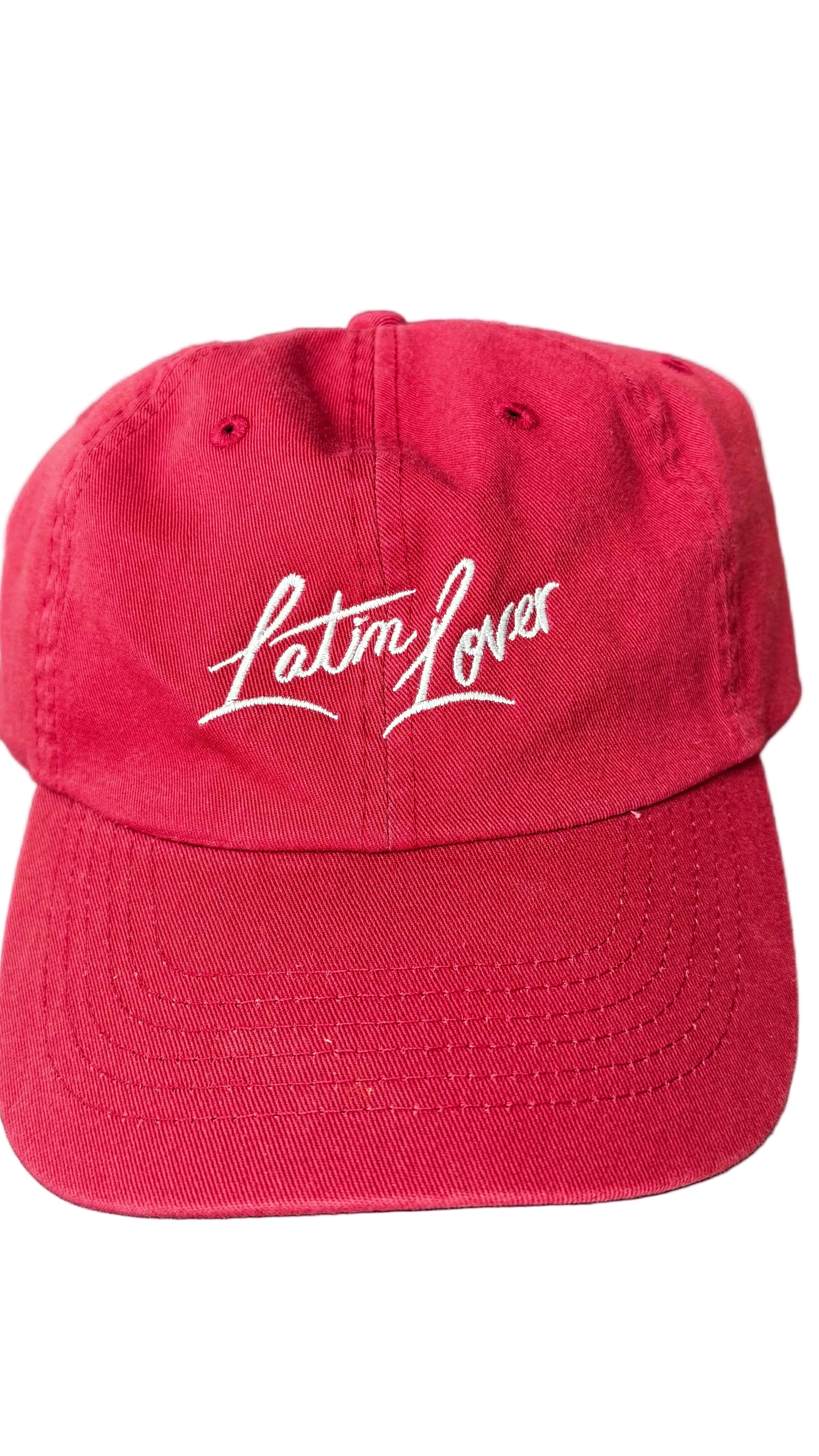A red baseball cap with 'Latin Lover' embroidered in white script across the front.