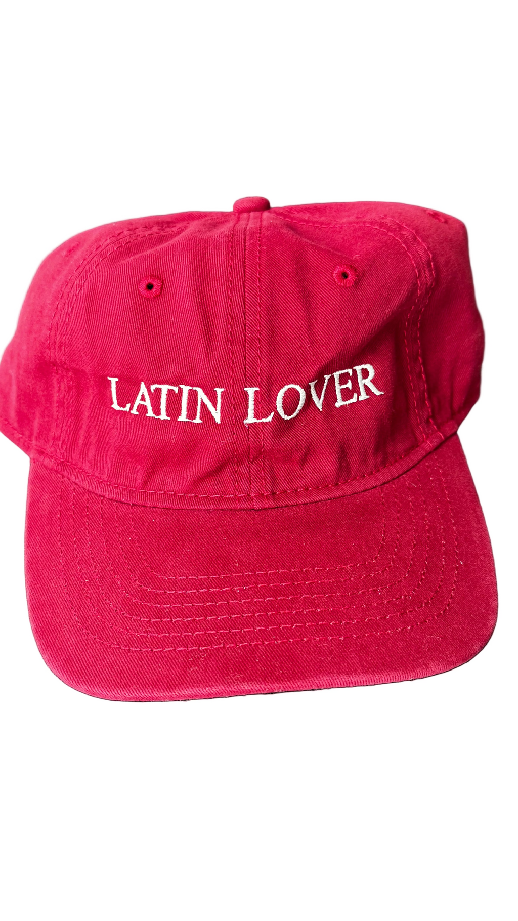 A red baseball cap with 'Latin Lover' embroidered in white script across the front.
