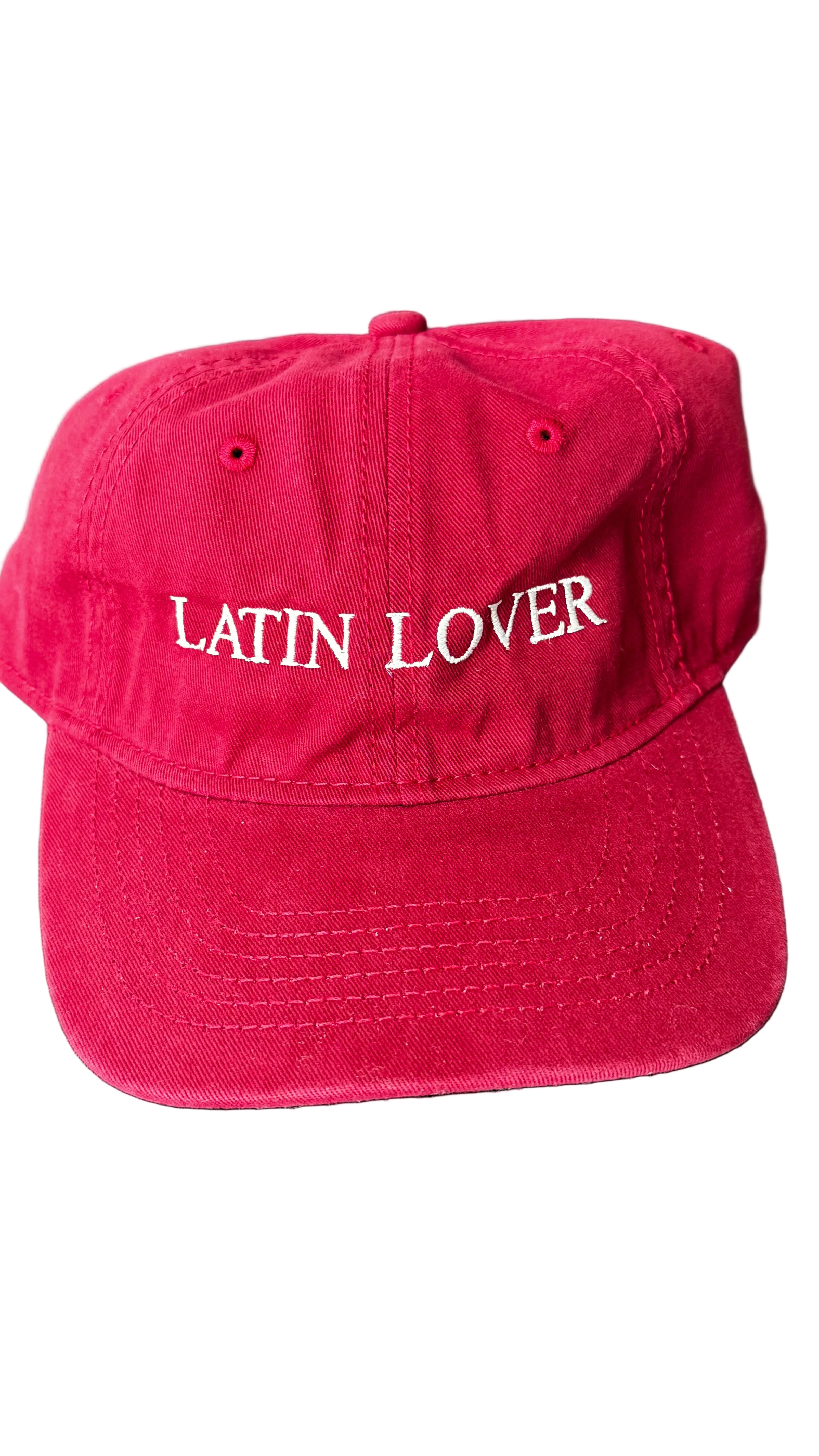 A red baseball cap with 'Latin Lover' embroidered in white script across the front.
